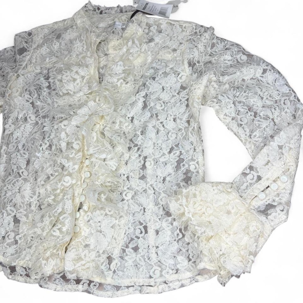 White lace‎ blouse with ruffle details and button
